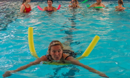 Mit einer Schwimmhilfe lernen die Erwachsenen die sorgfältigen Schwimmbewegungen. Fotos: DLRG