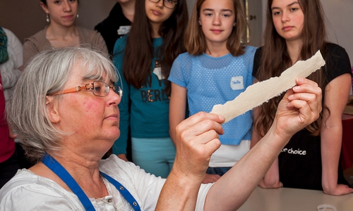 Viola Meradi führt Schülerinnen des Ratsgymnasiums in die Papierrestauration ein. Foto: HvFM/Peter Riewaldt