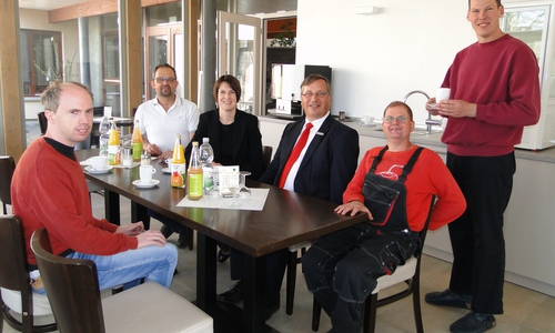 Ein gemütliches Plätzchen: Silke Comberg und Jürgen Kröger (4. v.r.), Vorstände der Kultur- und Sozialstiftung der Sparkasse Gifhorn-Wolfsburg, erkundeten mit Hofleiter Roland Bursian (links) und den Bewohnern Moritz Stoll, Jan-Hendrik Schmidt sowie Hannes Schulte das neue Hofcafé in Isenbüttel. Foto: Sparkasse Gifhorn-Wolfsburg