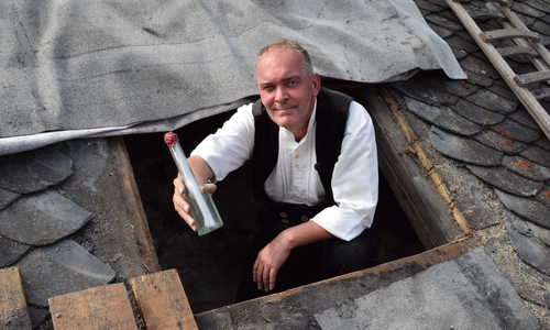 Peter Brandt zeigt noch einmal die Goslarer Flaschenpost, bevor er sie wieder unter dem Dach deponiert. Fotos (Stadt Goslar)