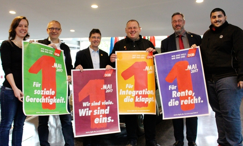 Inga Wolfram, Hartwig Erb, Michael Kleber, Thomas Heyn, Dietmar Balke und Khalil Neffati präsentieren die Motive der diesjährigen 1. Mai Kundgebungen. Foto: Sandra Zecchino