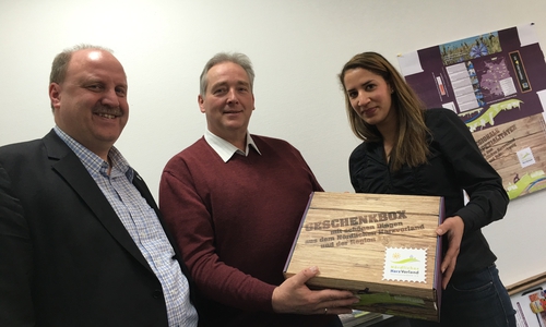 Andreas Memmert (Vorsitzender) und Jessica Lau (Geschäftsstelle) überreichen Frank Oesterhelweg (MdL) eine der neuen Geschenkboxen, Foto: Privat
