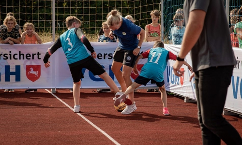 Wölfin Pia-Sophie Wolter zeigt den Kindern ein paar Tricks am Ball. Fotos: VfL Wolfsburg
