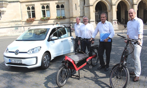 Stadtrat Christian Geiger, Oberbürgermeister Ulrich Markurth, Berater Frank Tristram und Michael Loose,  Leiter des Fachbereichs Stadtgrün und Sport (v. re.) präsentieren die Dienstfahrzeuge der Zukunft: E-Auto, Lastenrad und Pedelec. Foto: Alexander Dontscheff