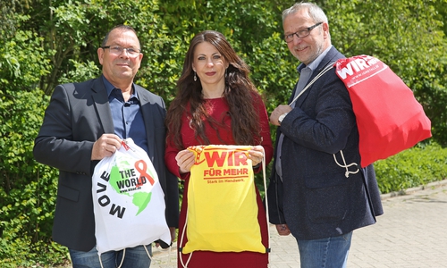 VW-Betriebsrat Joachim Thust, Vertrauensfrau Lidia Vella und Erster Bevollmächtigter Hartwig Erb präsentieren die aus alten T-Shirts genähten Stoffrucksäcke. Foto: Matthias Leitzke