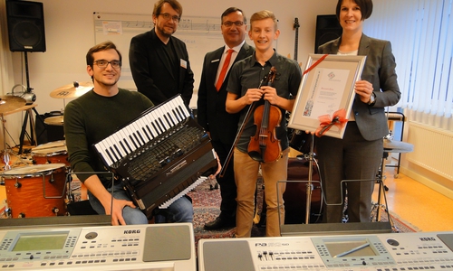 Umringt von Instrumenten fühlt sich Benjamin Enns (2.v.r.) am wohlsten: Von Silke Comberg und Jürgen Kröger, Vorstände der Kultur- und Sozialstiftung der Sparkasse Gifhorn-Wolfsburg, bekam er das Musikstipendium überreicht. Musiklehrer Nemanja Lukic (l.) und Musikschulleiter Peter Bönisch (2.v.r.) gratulierten. Foto: Sparkasse Gifhorn-Wolfsburg
