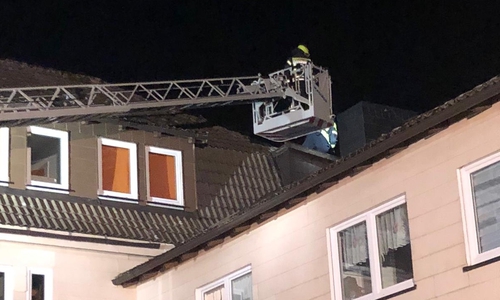 Mit einer Drehleiter musste die Feuerwehr Teile der Dachkonstruktion eines Mehrfamilienhauses sichern. 