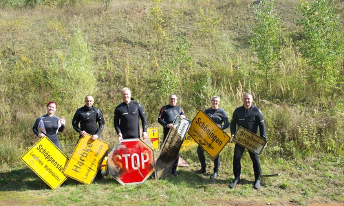 Die Taucher der DLRG Schöningen mit den Schildern aus dem Lappwaldsee. 