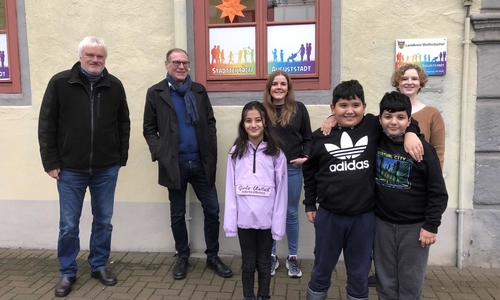 Harald Mikat und Ulrich Engelhardt vom Verein Humanitas übergeben den Scheck von 1.250 Euro an Jana Umlauft und Marleen Wagener vom Stadtteiltreff „Auguststadt“ (v.l.n.r.). Das Geld kommt den Kindern des Stadtteiltreffs zu Gute. Einige von ihnen waren bei der Scheckübergabe dabei.