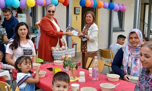 Nicole Gruhs, Leiterin der Wohnanlage Drömling, und Iris Bothe, Dezernentin für Jugend, Bildung und Integration, mit dem selbstgestalteten Kochbuch. 