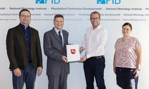 Staatssekretär Stefan Muhle aus dem Niedersächsischen Ministerium für Wirtschaft, Arbeit, Verkehr und Digitalisierung übergibt den Förderbescheid für den QVLS-Hightech-Inkubator den Projektverantwortlichen in der PTB. Von links nach rechts: Dr. Nicolas Spethmann (PTB), Dr.-Ing. Prof. h. c.  Frank Härtig (Vizepräsident der PTB), StS Stefan Muhle, Dr. Anna Cypionka (PTB).