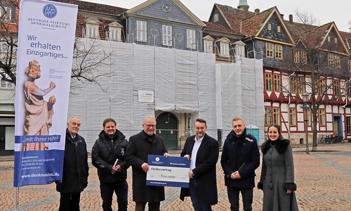 Aktuell ist das Standesamt eingerüstet und die Fassade kaum sichtbar. Die laufende Sanierung wird von der Deutschen Stiftung Denkmalschutz mit der stolzen Summe von 100.000 Euro gefördert. V. l.: Dietrich Burgund, Uwe Eicke, Walter Dröge, Ivica Lukanic, Dr. Philipp Knöfler und Sonja Schulz bei der Übergabe des symbolischen Förderschecks.