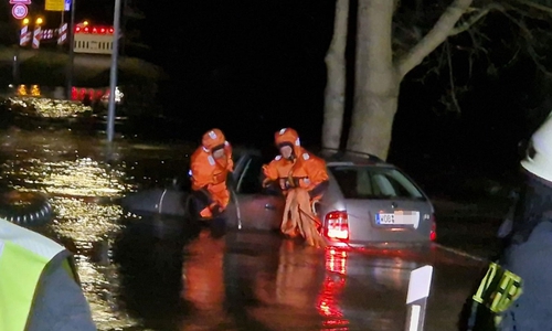 In Überlebensanzügen kämpften sich zwei Kameraden durchs Wasser.