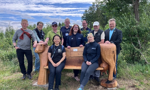 Die Delegation, bestehend aus dem Geopark-Team und den zwei Entsandten der UNESCO während der Bereisung an einer der zwei neuen Kuhbänke entlang des Höhenvieh-Pfads in Tanne.
