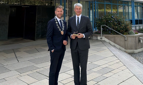 Bundesverkehrsminister Steffen Bilger (re.) mit Oberbürgermeister Dennis Weilmann vor dem Wolfsburger Rathaus.