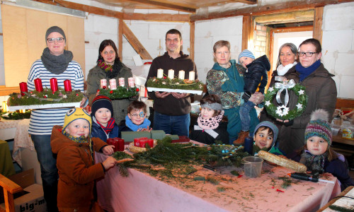 Eltern sowie einige Jungen und Mädchen aus dem Kindergarten fertigten schöne Gestecke und Adventskränze an. Foto: Bernd-Uwe Meyer