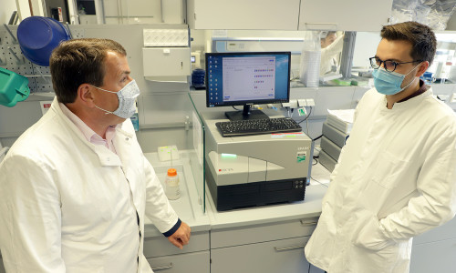 Promovend Alexander Heinz (r.) erklärt Axel Burghardt, Geschäftsführer des Klinikums Wolfenbüttel, wie die Tests auf Covid-19 im Labor des BRICS ausgewertet werden. 