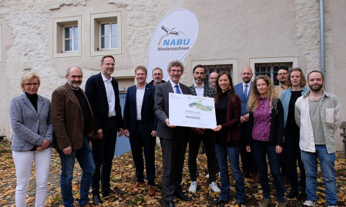Übergabe des Förderbescheids durch Umwelt-Staatssekretär Frank Doods an Marieke Neßmann und das Team der ÖNSA