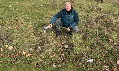 Ratsherr Thorsten Wendt zeigte am Freitag die vermüllte Wiese neben dem Aldi-Grundstück.