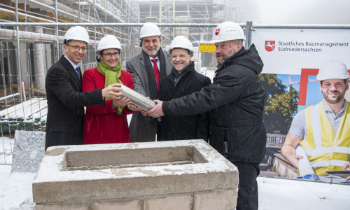 Die Zeitkapsel wird in den Grundstein gelegt (von links): Wissenschaftsminister Falko Mohrs, Universitätspräsidentin Dr.-Ing. Sylvia Schattauer, Prof. Arnold Adam (TU Clausthal), Finanzminister Gerald Heere und Marcus Rogge, Leiter des Staatlichen Baumanagements Südniedersachsen.