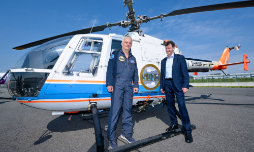 (von links) DLR-Testpilot Uwe Göhmann und Bereichsvorstand Luftfahrt Dr.-Ing. Markus Fischer vor der BO 105 auf der ILA Berlin 2024.