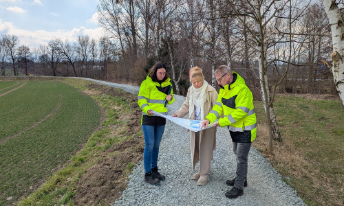  Am Schleusendamm in Wiedelah erläutern Dirk Sielaff, Fachdienstleiter Umwelt und Gewässerschutz der Stadt Goslar, und Teresa Klingenberg von der Unteren Wasserbehörde der Stadt Goslar, Oberbürgermeisterin Urte Schwerdtner die Sanierungsmaßnahme.