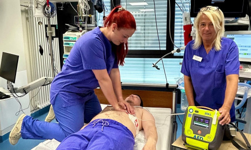 Linda Baumgarten (v. li.) und Marion Kruse (beide Fachschwestern Anästhesie- und Intensivmedizin) demonstrieren an einem Kollegen eine simulierte Reanimation mit einem AED.