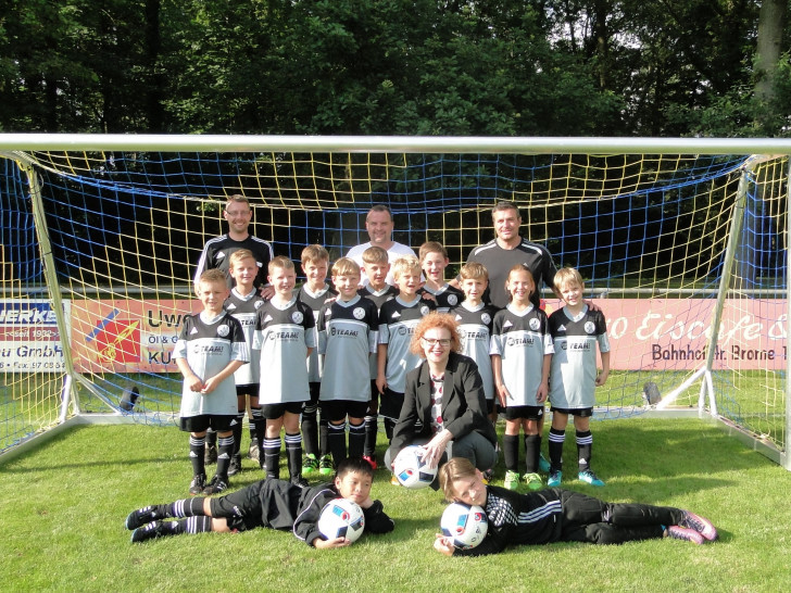 Die Trainer Patrick Stau, Meik Hecker und Toni La Rocca und die F-Jugend des FC Germania Parsau freuen sich über die neuen Fußballtore. Foto: Sparkasse Gifhorn-Wolfsburg