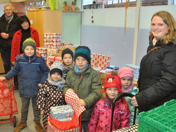 Die Kinder des Kindergartens Kilindum haben mit Larissa Hettich (rechts) die Geschenke für Tafel-Kinder mitgebracht. Horst Rimke (von links) und Juliane Liersch freuen sich über die Spende. Foto: DRK