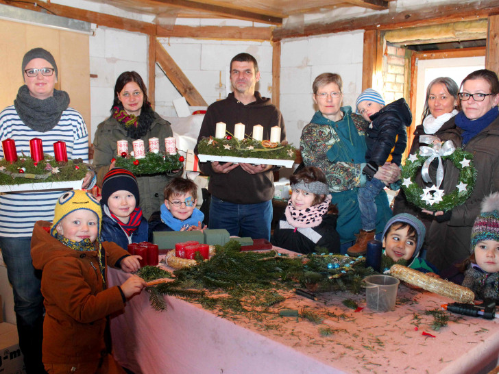Eltern sowie einige Jungen und Mädchen aus dem Kindergarten fertigten schöne Gestecke und Adventskränze an. Foto: Bernd-Uwe Meyer