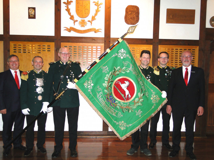 Vor der Tafel aller Könige der Schützengesellschaft Hankensbüttel und Isenhagen e.V. präsentierte der amtierende König und stellvertretender Schatzmeister Jürgen Schneck (2.v.l.) mit Fahnenträger Thomas Riedel (3.v.l.), Oberst Frank Schmidt (3.v.r.) und Zugführer Jörn Hüsemann (2.v.r.) dem Vorstand der Kultur- und Sozialstiftung der Sparkasse Gifhorn-Wolfsburg, Jürgen Kröger (l.) und Christian Eichler( r.) die restaurierte Fahne pünktlich vor dem Schützenfest. Foto: Kultur- und Sozialstiftung der Sparkasse Gifhorn-Wolfsburg