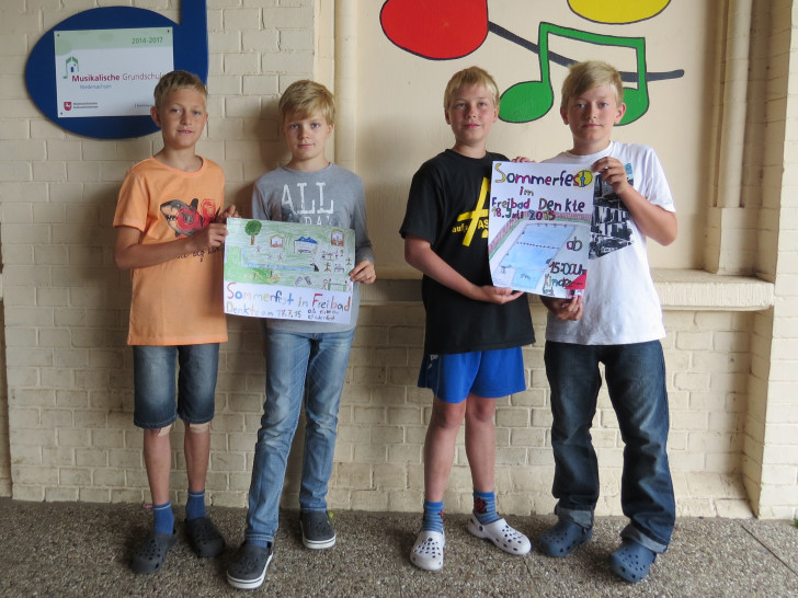 Tim und Sebastian, Klasse 4a und Louis und Leon Klasse 4b zeigen stolz ihre entworfenen Plakate zum Sommerfest