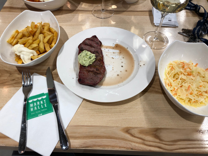 Die einzelnen Komponenten in der Markthalle: Rumpsteak, Kräuterbutter, Pommes frites mit Mayonaise und Krautsalat.