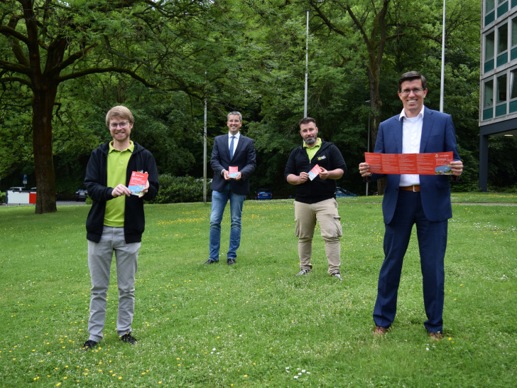 Sparkassenregionaldirektor Jens Müller (rechts), Oberbürgermeister Dr. Oliver Junk (2.v.li.), sowie Joshua Friederichs (links) und Martin Sänger von der Stadtjugendpflege präsentieren den Ferienpass 2020.
