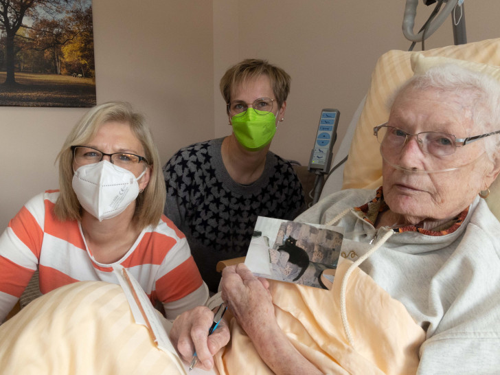 Von links nach rechts: Hospiz-Krankenschewster Silke Tobien, Schwiegertochter Regina Laukamp und Gerda Fischer, die ein Foto ihrer Katze Hexe hält. 