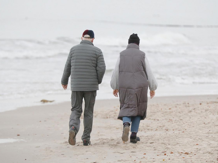 Zwei Personen laufen am Strand (Archiv)