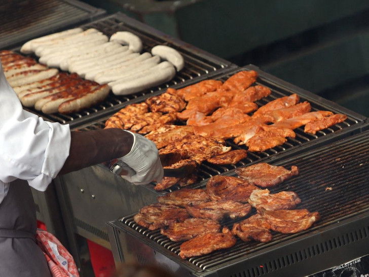 Hähnchenschnitzel und Würste auf einem Grill (Archiv)