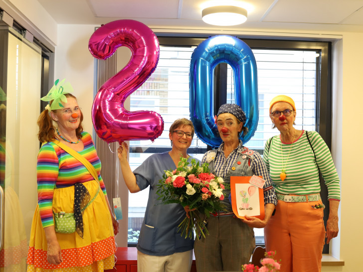 20 Jahre Klinik-Clowns im Klinikum Wolfsburg: Oberärztin Dr. Alina Biering aus der Kinderklinik (2.v.li.) überreicht Blumen an das Clowns-Team Betty Brause (li.), Feodora (2.v.r.) und Olga (re.).