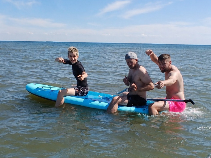 Die Sportjugend-Ferienbetreuer Sal, Lennart und Jonas testen die neuen SUPs.