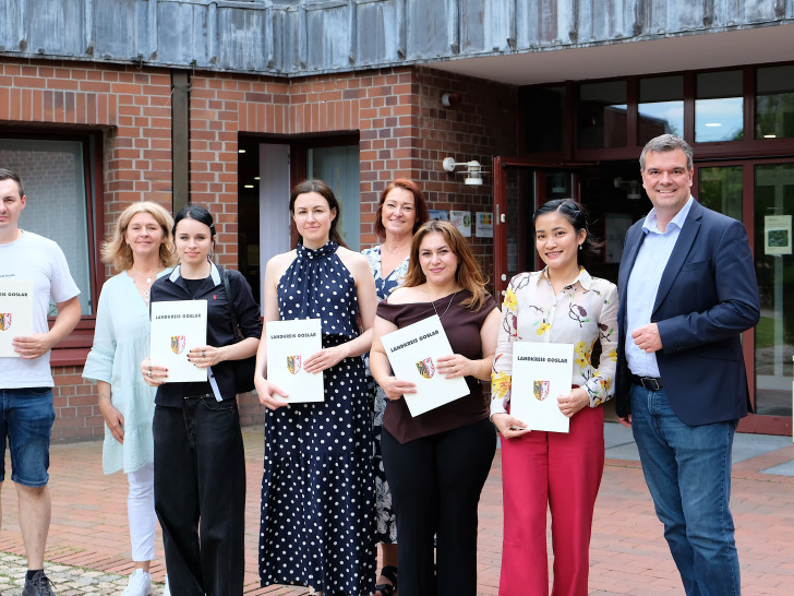 Gruppenfoto vor dem Kreishaus: Landrat Dr. Alexander Saipa (rechts) gemeinsam mit den eingebürgerten Personen und zwei Mitarbeiterinnen aus der Ausländerbehörde. 