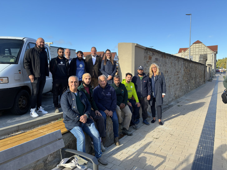 Das Projektteam freut sich über die erfolgreich abgeschlossene Restaurierung der denkmalgeschützten Mauer.